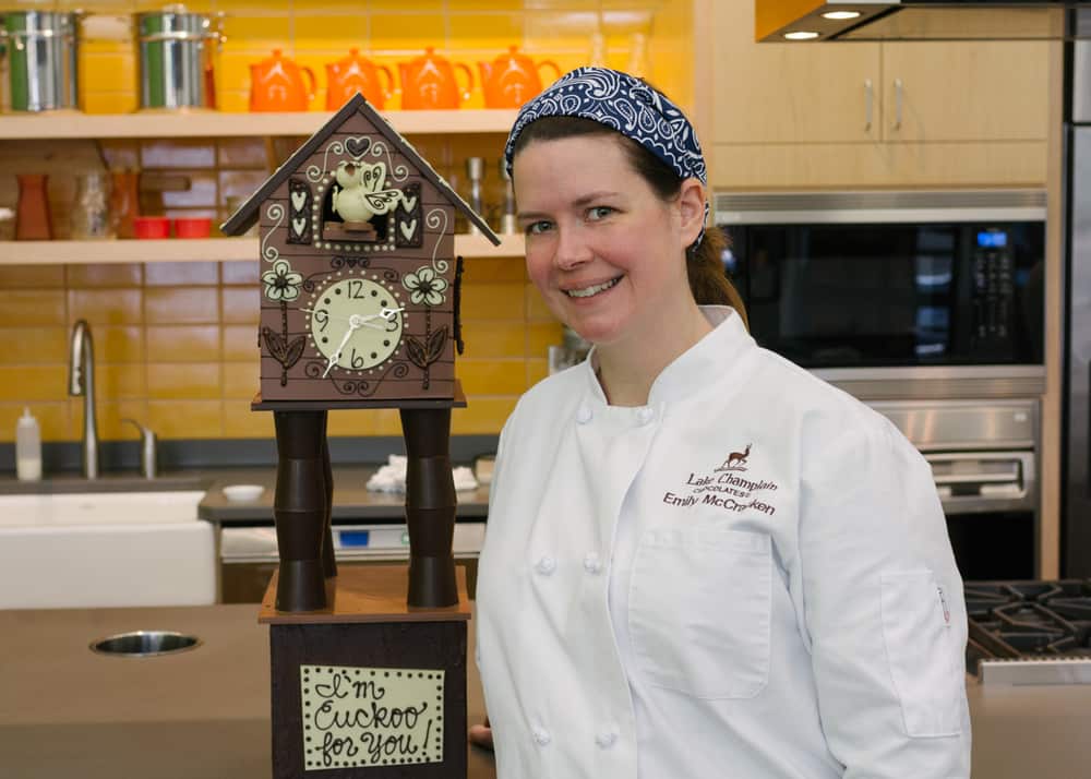Emily McCracken in front of a scaled down version of her Food Network chocolate cuckoo clock