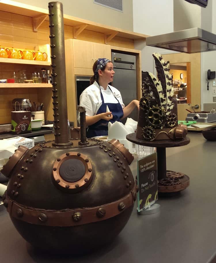 Emily McCracken, standing behind her chocolate steampunk creations, teaching a chocolate bar class in South End Kitchen.